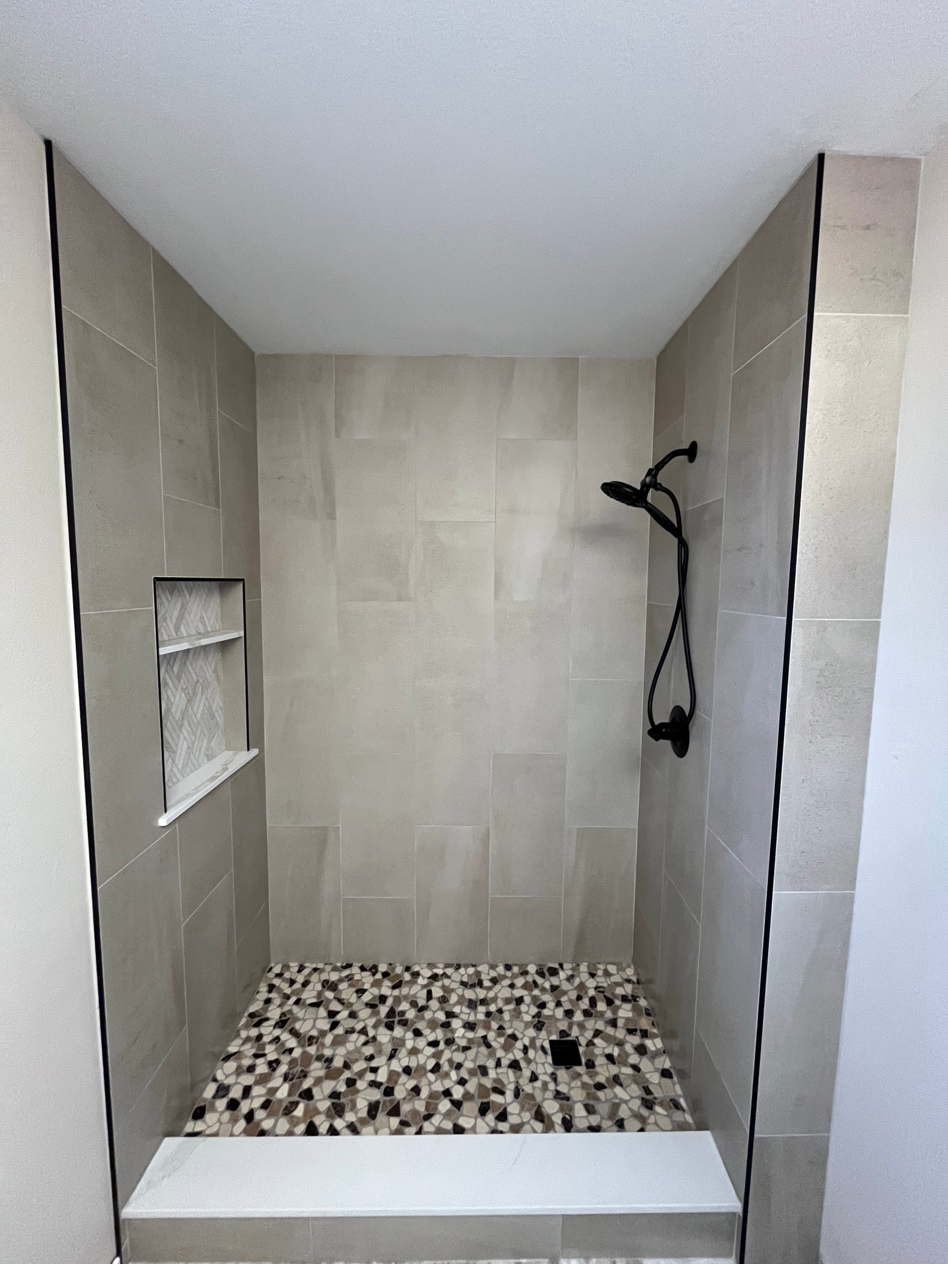 Walk-in shower with natural pebble floor tile in Palm Springs spa bathroom