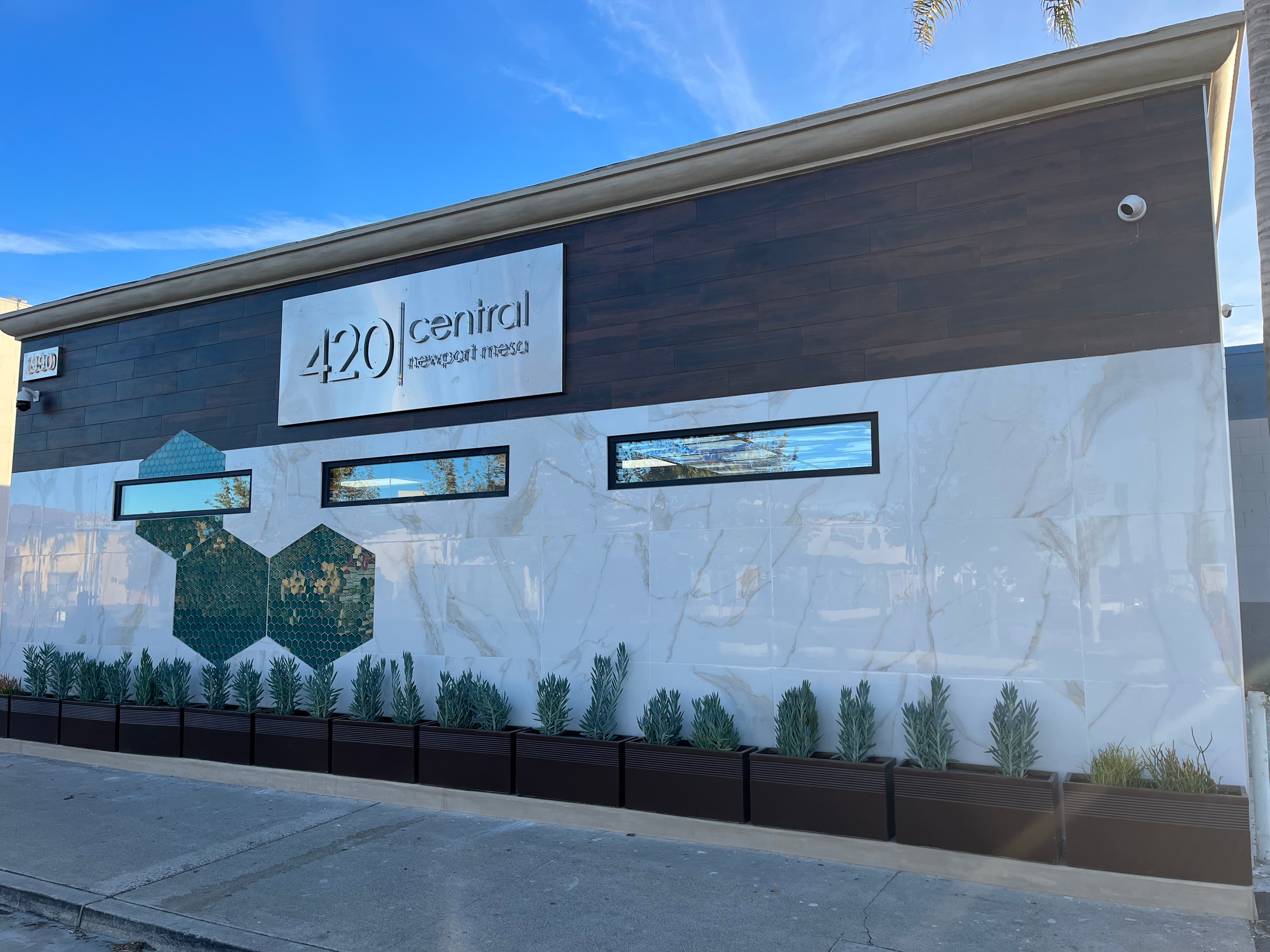 Commercial storefront exterior with large format marble tile and decorative hexagon feature wall in Costa Mesa