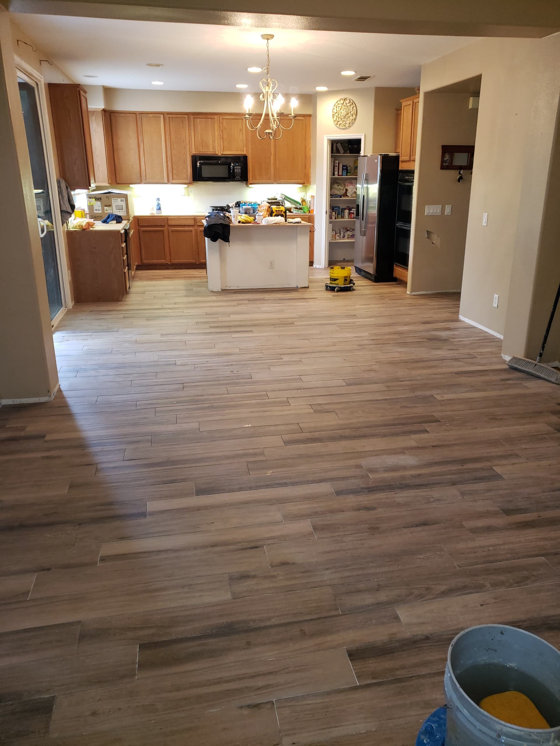Open concept seamless tile flooring throughout Murrieta home remodel