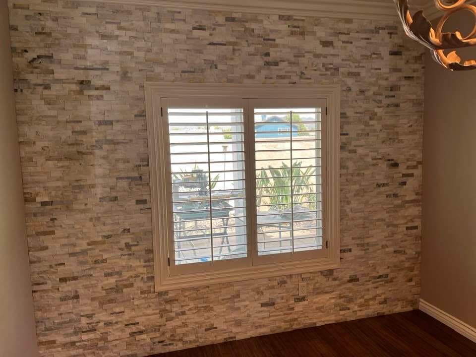 Stacked stone accent wall installation around window in Temecula Wine Country home