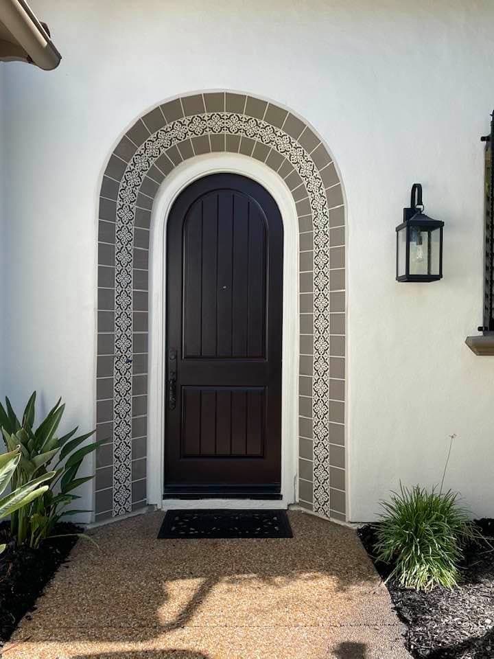 Custom tile surround for arched entry door in Coachella Valley residence