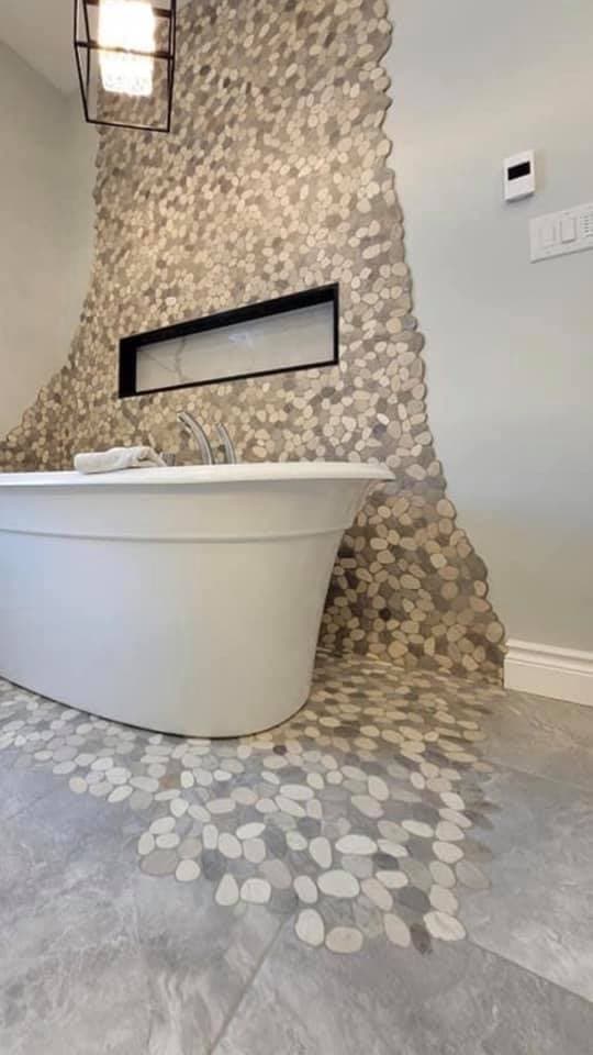 Custom tub surround with decorative accent wall tile in Riverside California bathroom