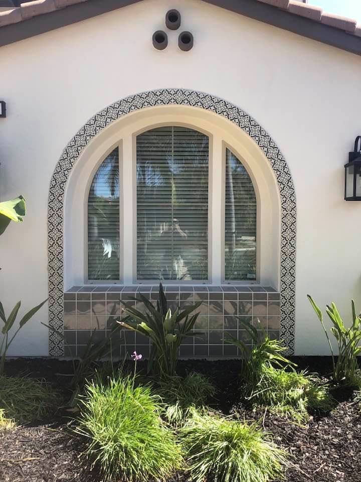 Decorative tile archway around exterior window in Winchester home